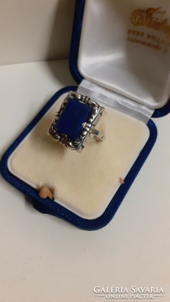 Old, beautiful, marked silver ring in a patterned setting, encrusted with a polished lapis lazuli stone