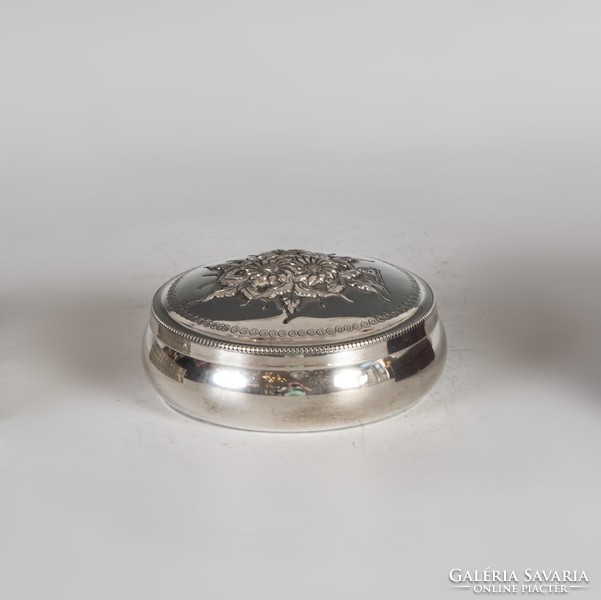Silver round box with floral decoration on the lid