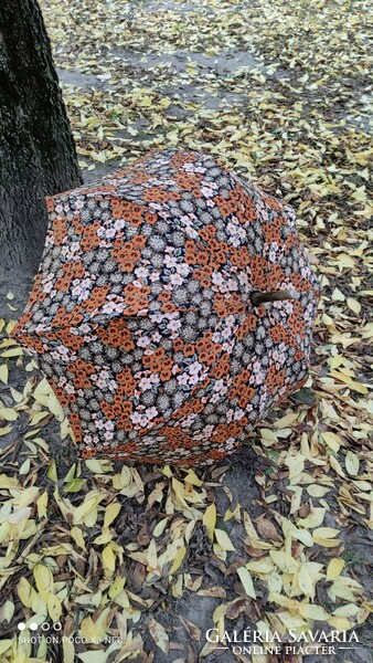 Antique old umbrella with floral pattern in autumn colors