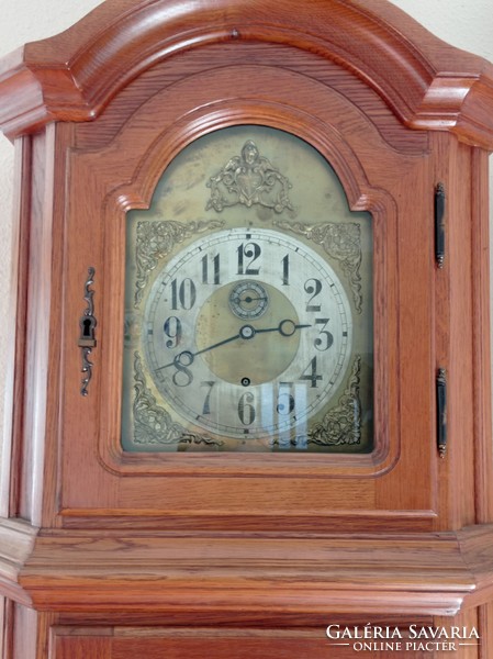 A clock in an oak case with a functioning antique clock mechanism, 2 meters long