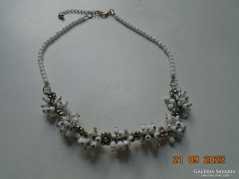 Necklaces made of polished, faceted white crystal pearl clusters and silver-plated flowers.