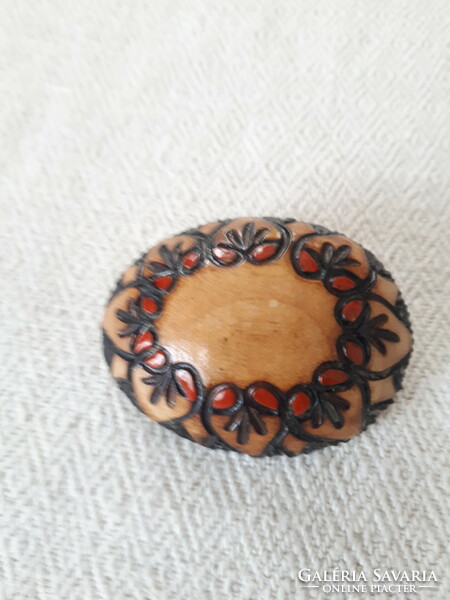 Wooden brooch with burnt decoration