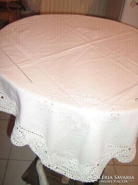 Beautiful handmade crocheted tablecloth with azure woven tablecloth