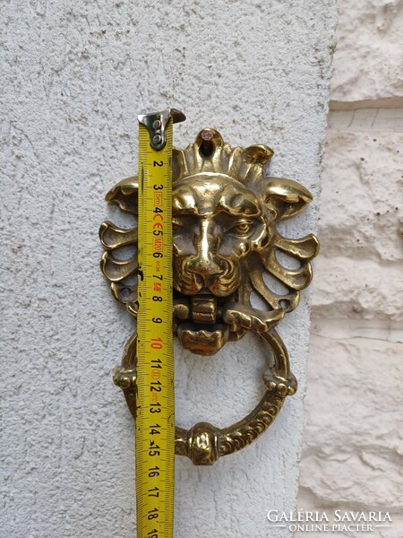 A knocker with a lion's head made of copper. Also a video!