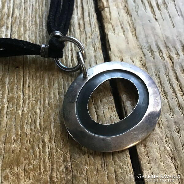 Silver pendant with silver fittings on a leather necklace