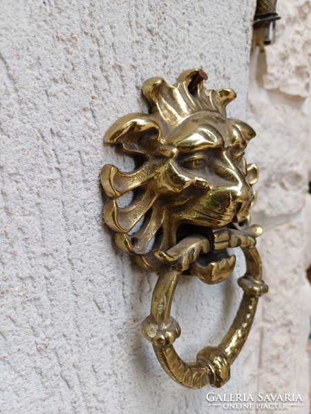 A knocker with a lion's head made of copper. Also a video!