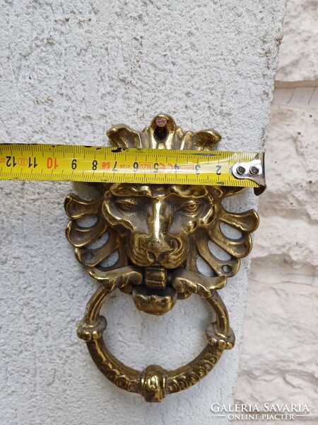 A knocker with a lion's head made of copper. Also a video!