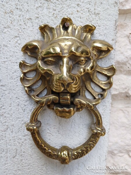 A knocker with a lion's head made of copper. Also a video!