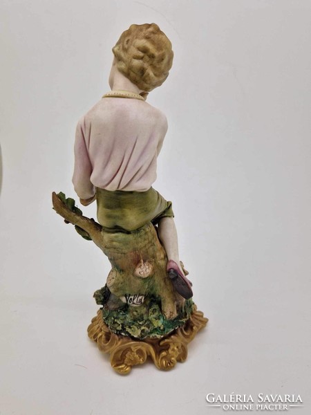 Capodimonte dreaming boy a figure on a log 18cm