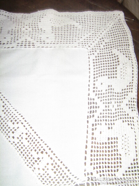 White tablecloth with beautiful handmade crochet edges and inserts