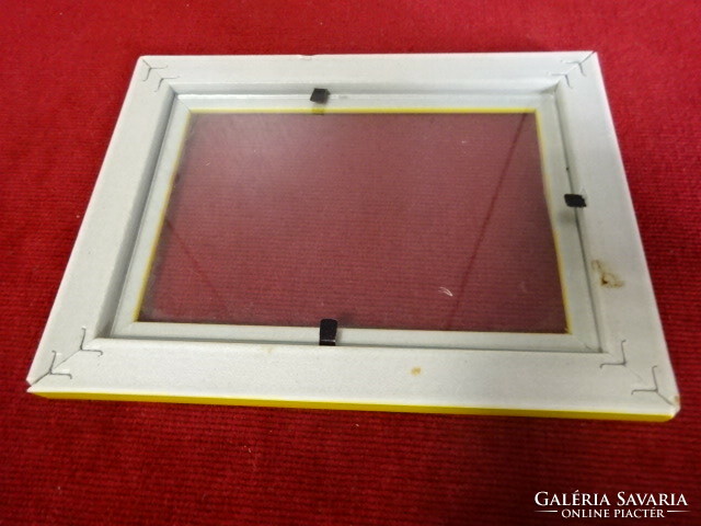 Yellow plastic picture frame with glass sheet. Jokai.