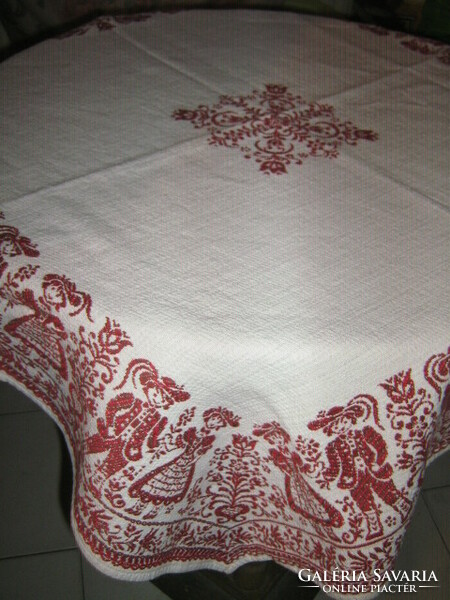 Beautiful vintage bavarian motif burst on white background Tyrolean girl-boy and floral kind woven tablecloth