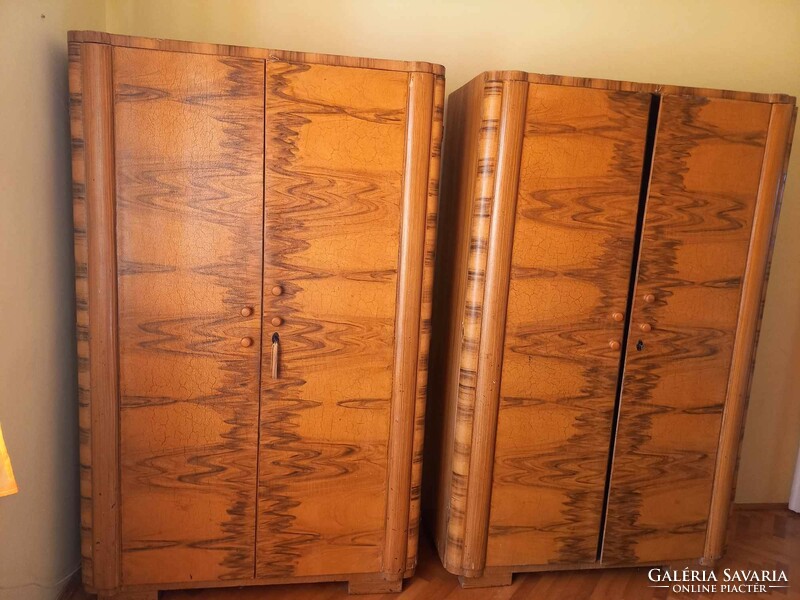 Art deco pine cabinet with a pair of fleur-de-lis paintings