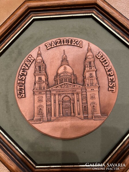 Saint Stephen's Basilica wall decoration, stone carving in a brown wooden frame.