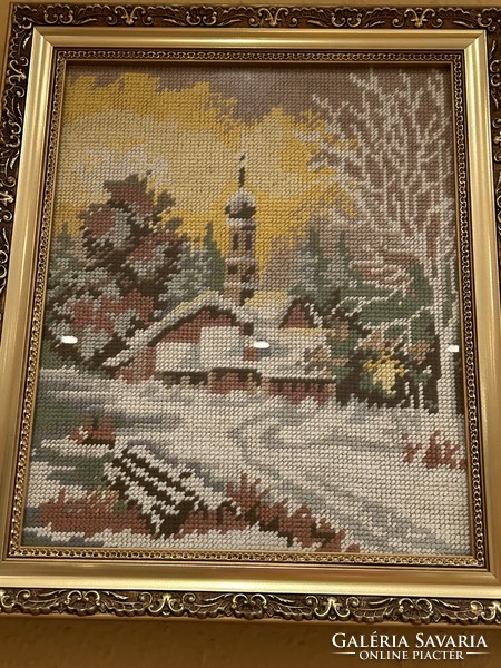 Framed, glazed needle tapestry of a winter landscape with a church, in a beautiful gold frame