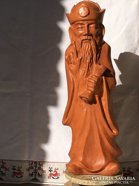 The wise, large-scale terracotta statue.