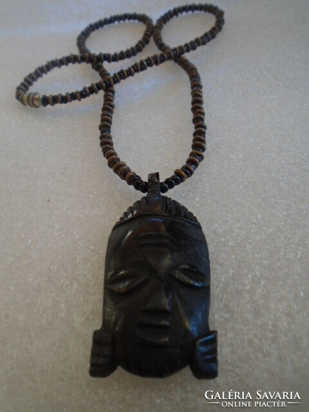 A blunt head carved from ebony, a brutally serious necklace, a very massive chain weighing 30 grams