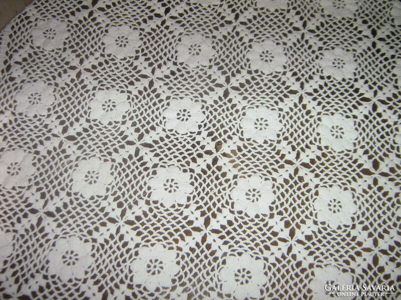 Beautiful white hand crocheted antique lace tablecloth with flower pattern