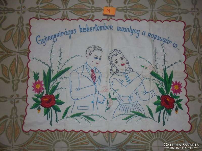 Old hand-embroidered scene wall protector with the inscription 