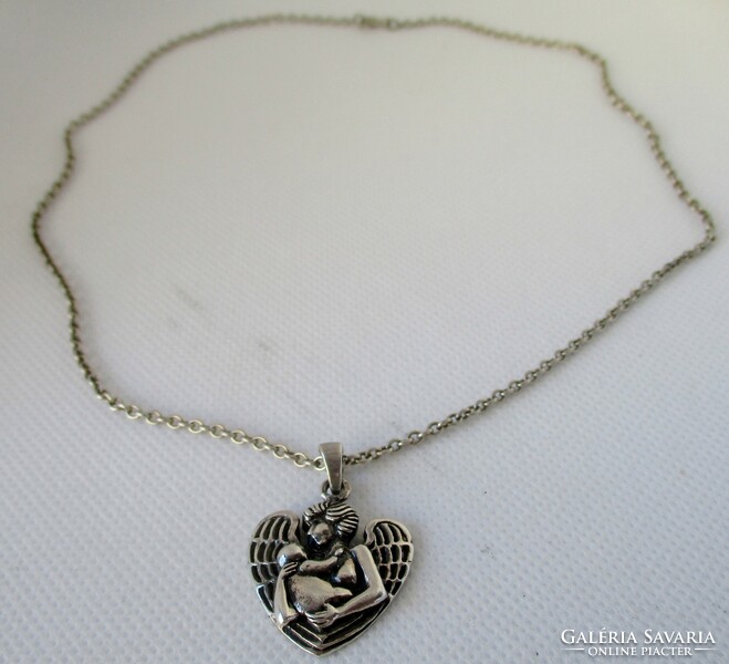 A very special old silver guardian angel pendant on a silver necklace