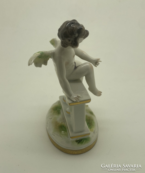 Antique continental porcelain putto sitting on the fence 13cm