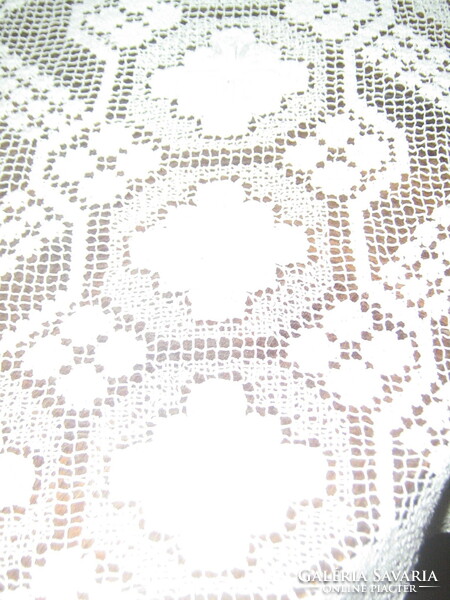 Beautiful festive snow-white lace tablecloth made in a special Art Nouveau style