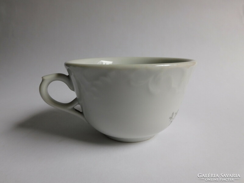 Antique, thick-walled tea cup with violet pattern