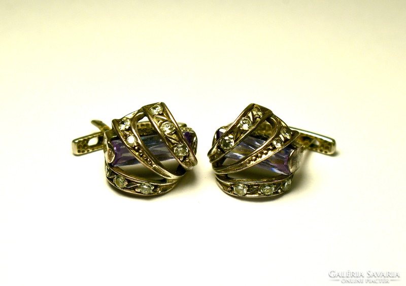 Decorative and spectacular silver earrings inlaid with small stones with a hidden larger polished stone