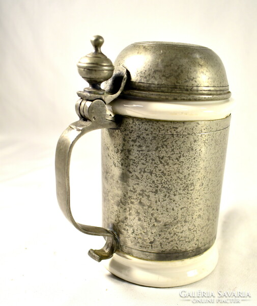 A jug with a tin lid and a porcelain insert with a coat of arms!