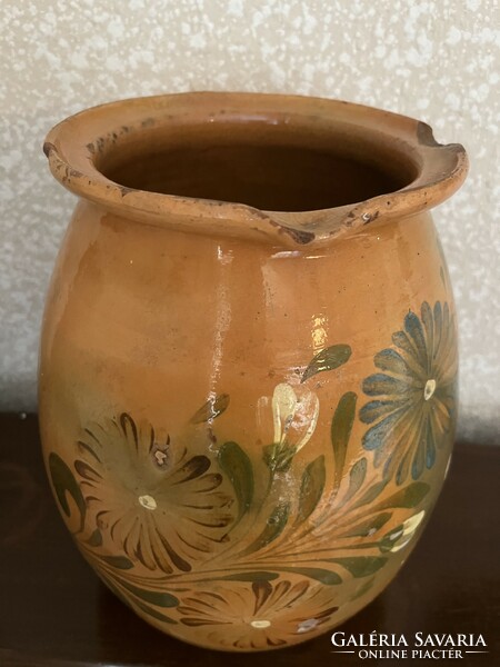 Large antique brown glazed earthenware pot with ceramic flower motif