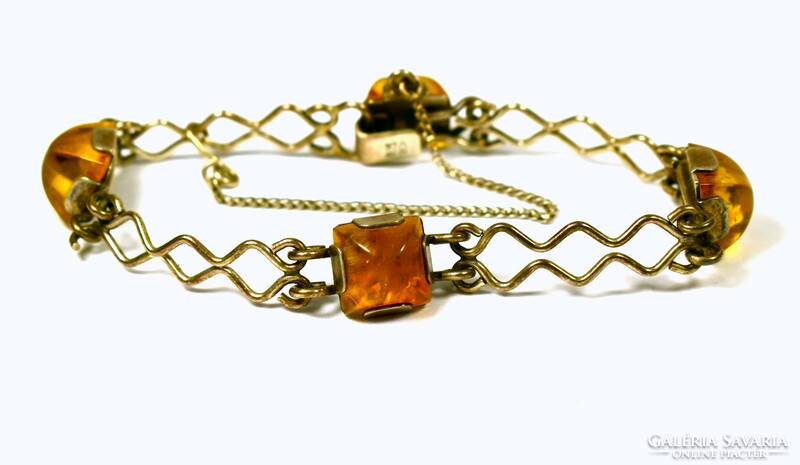 Decorative silver bracelet with polished amber stones