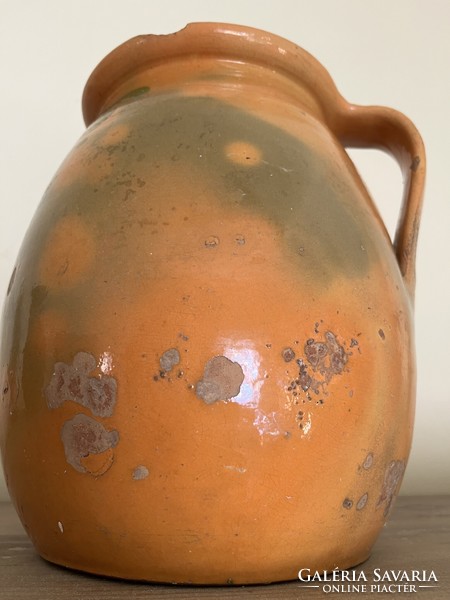 Large antique brown glazed earthenware pot with ceramic flower motif