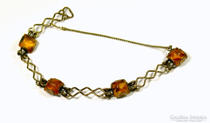 Decorative silver bracelet with polished amber stones