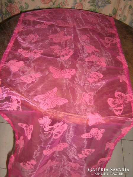 Beautiful vintage butterfly running on organza tablecloth