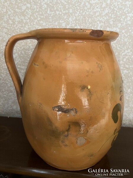 Large antique brown glazed earthenware pot with ceramic flower motif