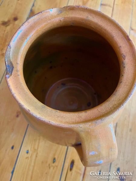 Large antique brown glazed earthenware pot with ceramic flower motif