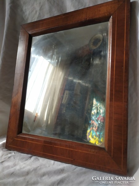 A small old mirror in a Biedermeier frame