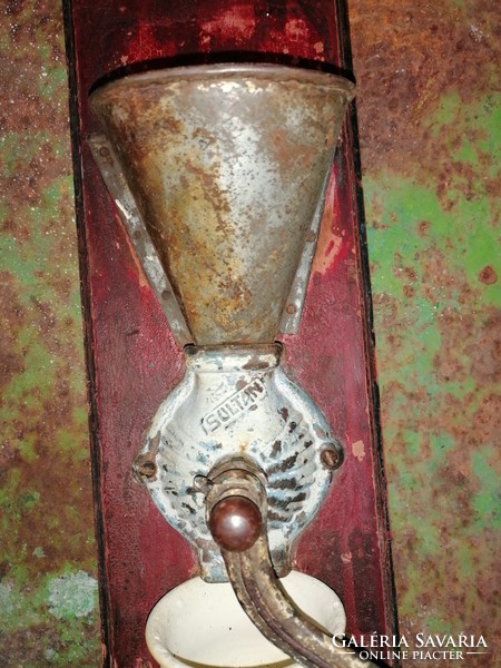 Rustic, antique, wall-mounted coffee grinder