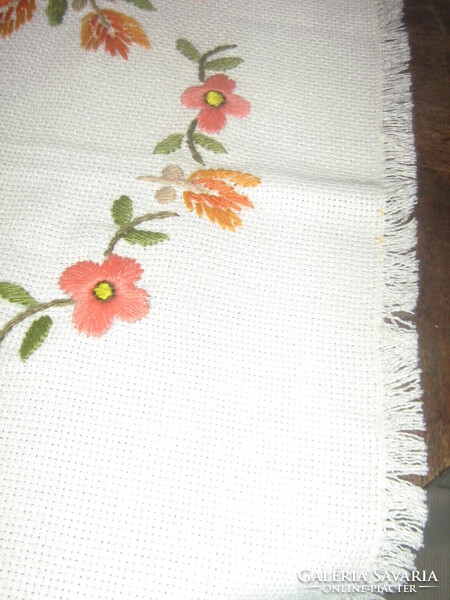 Beautiful hand-embroidered floral tablecloth runner with fringed edges