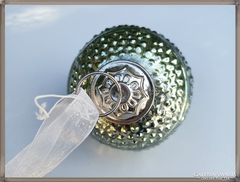 Thicker old glass sphere ornament with a light olive green color and a bulging pattern./ Christmas /