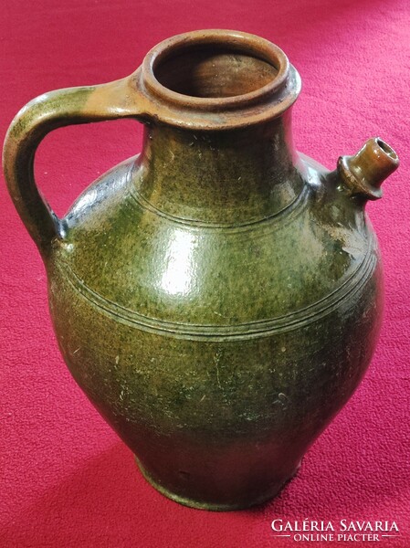 Folk earthenware jug with spout, handle, green glaze