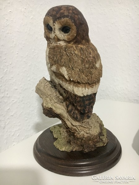 Vintage owl statue on wooden base