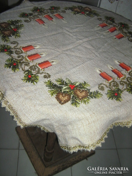 A dreamy Christmas tablecloth richly embroidered by hand with a lacy edge