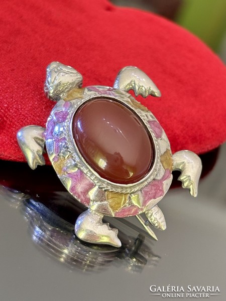 A stunning silver turtle brooch with a large carnelian stone
