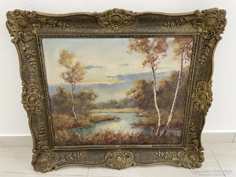 Antique landscape painting with a river in a forest in a blonde frame