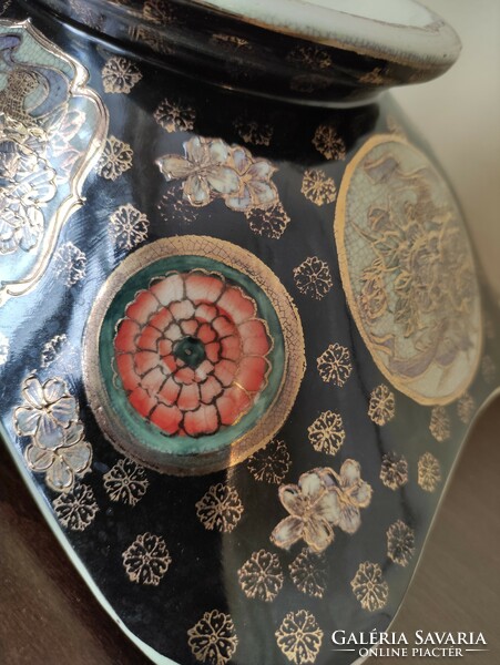 A huge two-handled, richly gilded antique Chinese porcelain bowl with a colorful scene