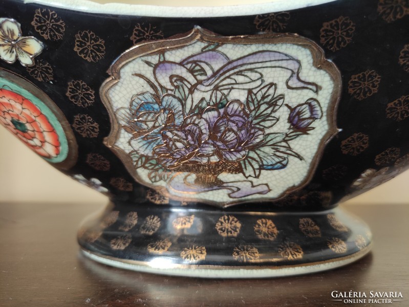 A huge two-handled, richly gilded antique Chinese porcelain bowl with a colorful scene