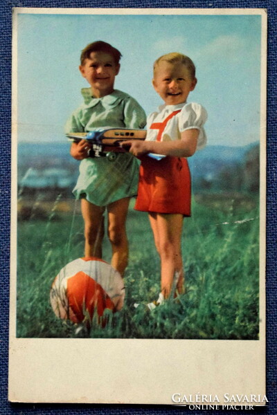 Old nostalgia photo postcard - little boys with a ball, a toy airplane