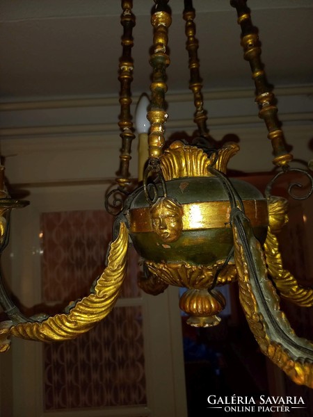 Very old chandelier with painted and gilded figural decoration