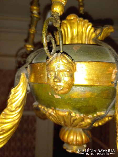 Very old chandelier with painted and gilded figural decoration